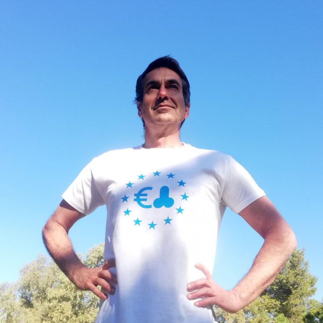 Dark haired man wearing t-shirt with blue print
