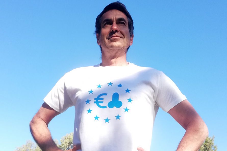 Dark haired man wearing t-shirt with blue print