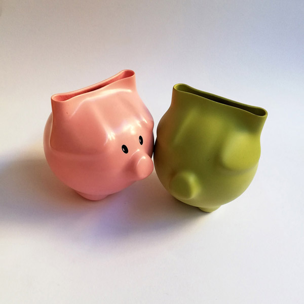 A pink and a lime dip moulded plastic piggy banks.