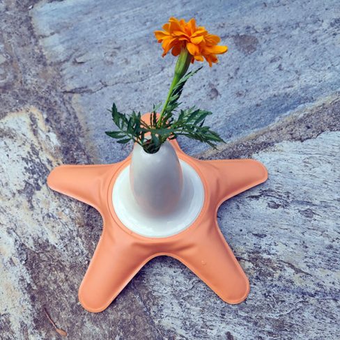 Orange inflatable flower vase and orange flower