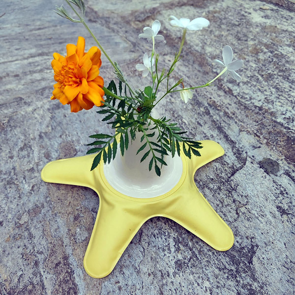 Yellow inflatable flower vase with orange flower